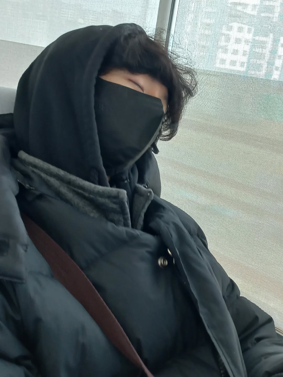 Photo by 찬혁 on February 16, 2026. May be an image of duffle coat, face mask, parka and text.