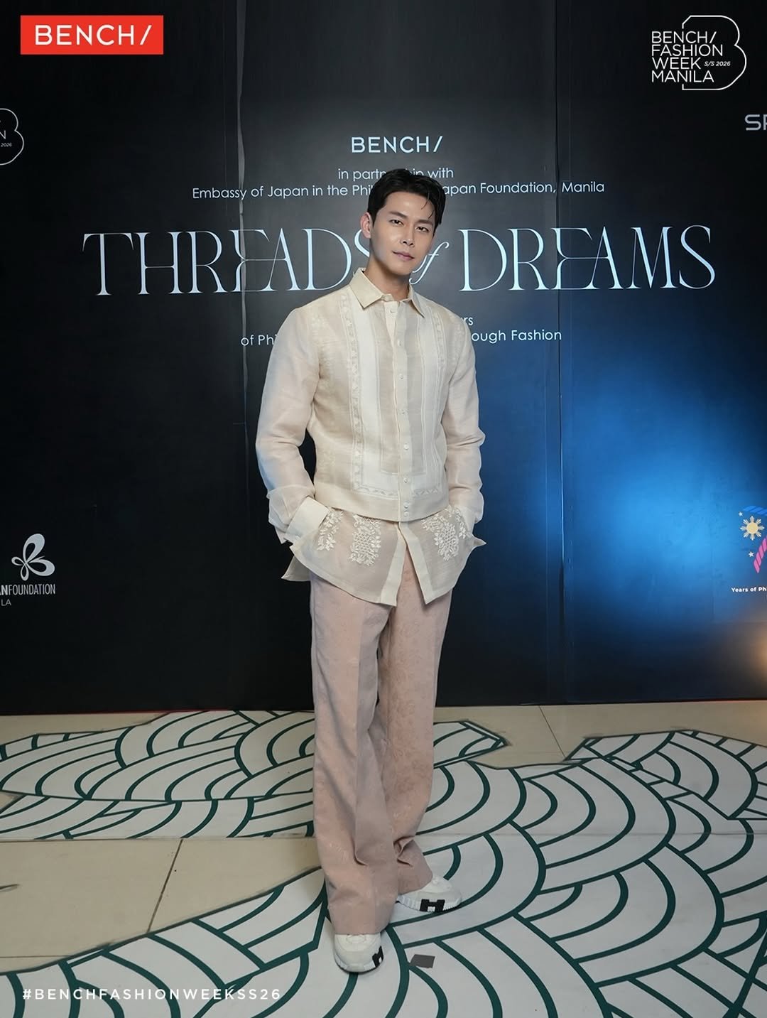 Photo shared by Theo Jang on April 21, 2026 tagging @benchtm. May be an image of suit, magazine, dinner jacket, carpet, barong, blazer and text that says 'BENCH/ FASHION WEEK 2028 FASHION MANILA in partr Embassy o of Japani the Phi THRIAD H/ nwith in with apan Foundation, panFoundation,Manil Manila DREAMS ough oughFashion Fashion of ofPh Ph NFC NFOUNDATION Yearser #BENGHFASHIONWEEKSS26 BENCHFASHIO'.