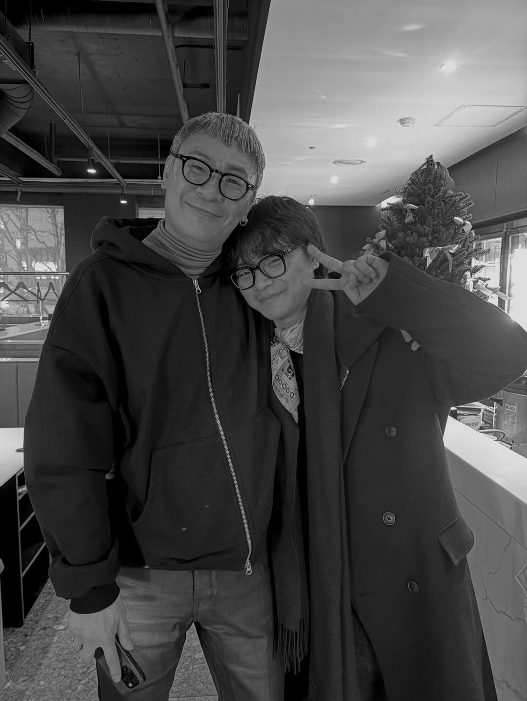 Photo shared by kimrowon on February 12, 2026 tagging @hanugi00, and @gkdldua_hyej. May be a black-and-white image of one or more people, people standing, eyeglasses, overcoat, duffle coat, parka and text.