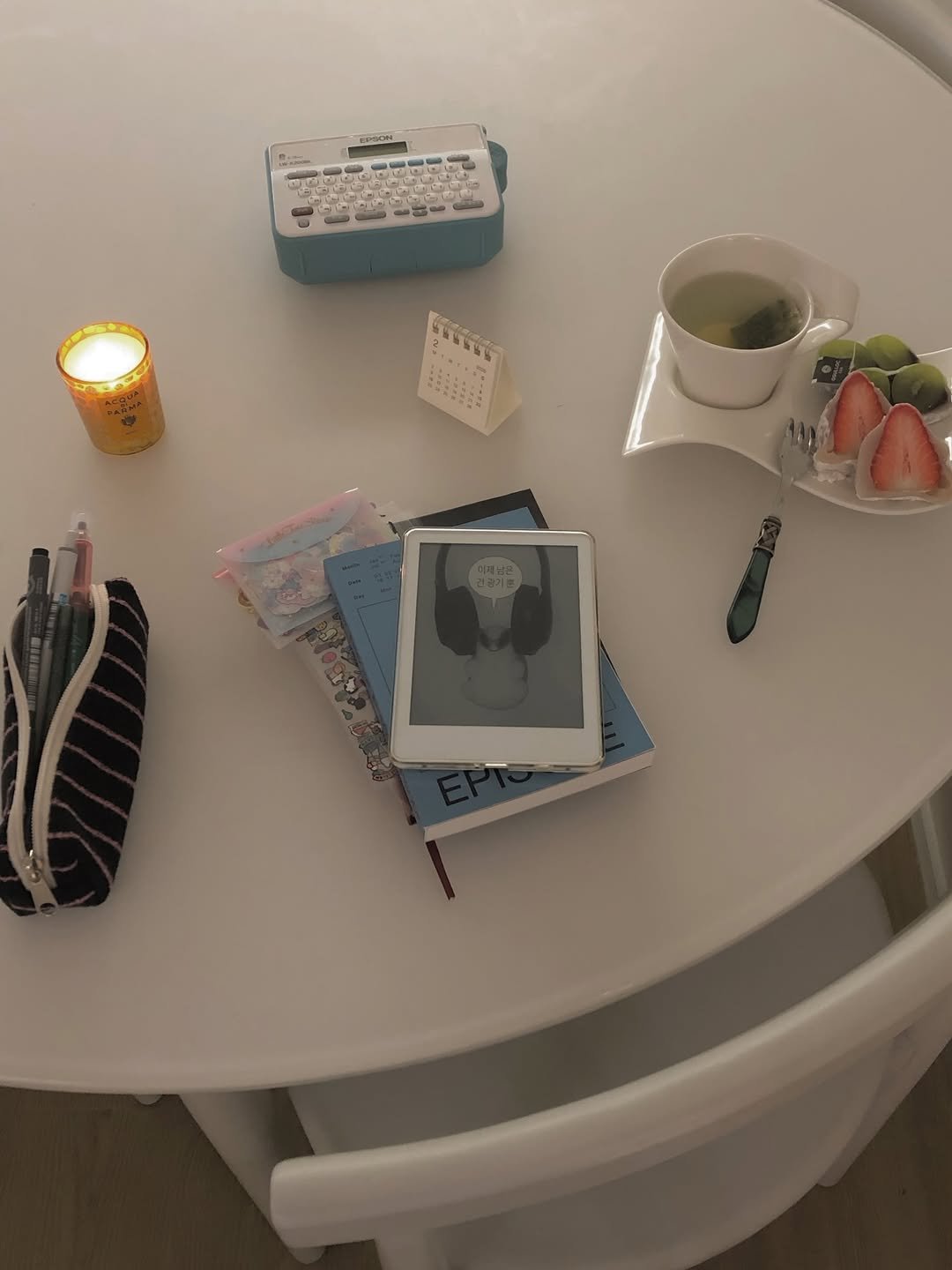 Photo by Taehee on February 11, 2026. May be an image of diary, candle, typewriter, desk, tea, teacup, pen, book and text.