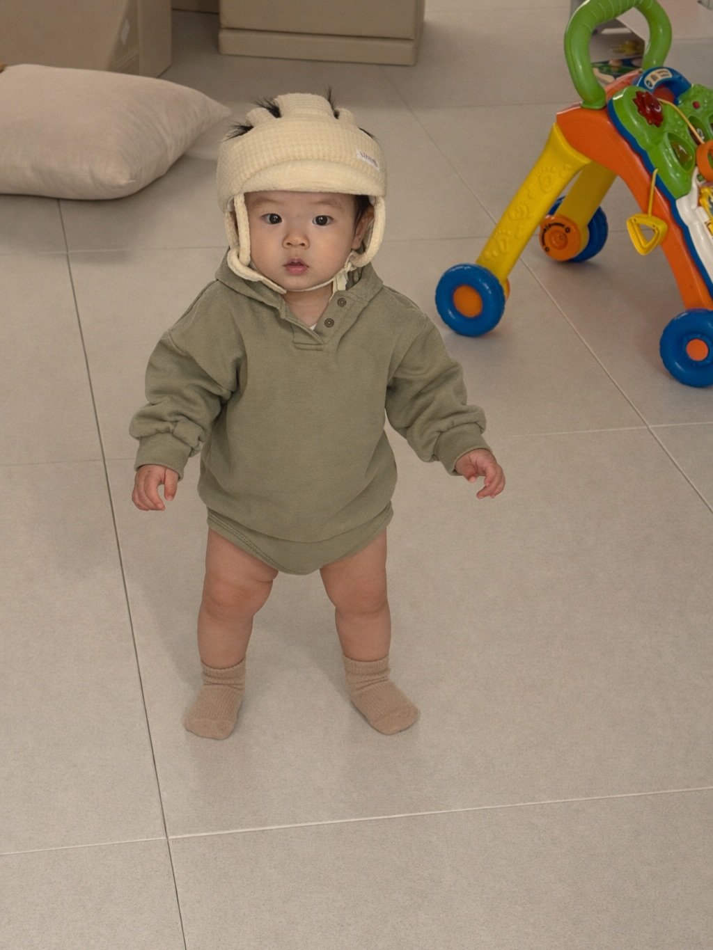 Photo by 땡큐girl on December 22, 2025. May be an image of baby, standing, duffle coat, hat and text.