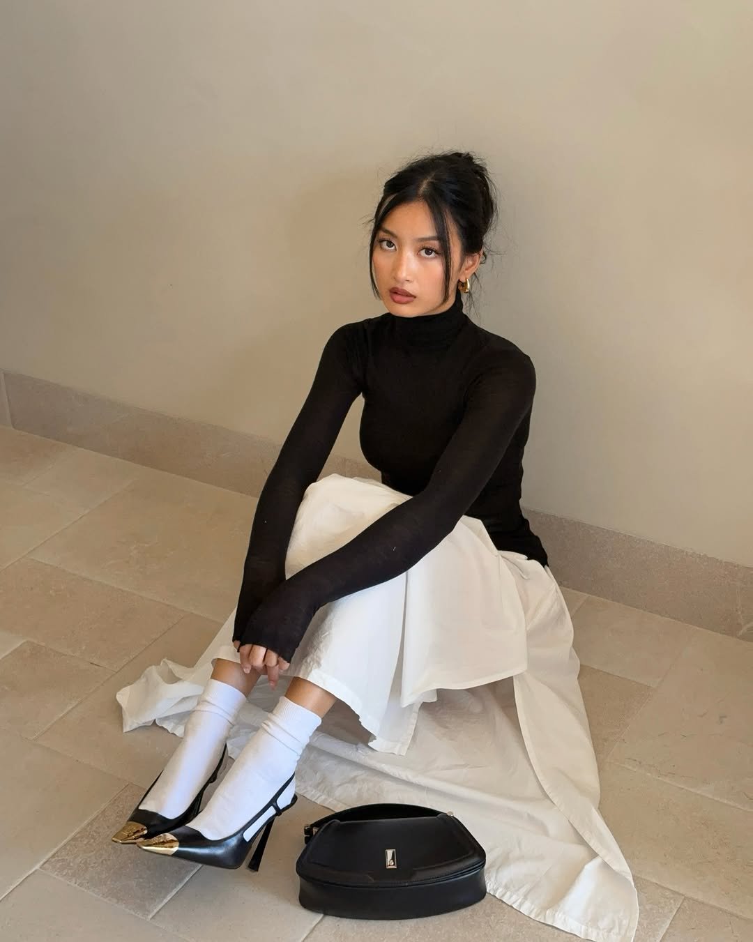 Photo by Thanya Wong on September 22, 2025. May be an image of 1 person, dress, turtleneck and text.