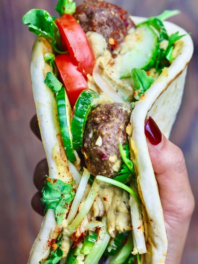 Photo by Mediterranean Food & Diet | Easy Recipes | Suzy Karadsheh on November 22, 2025. May be an image of souvlakia, gyro, sandwich, cucumber, hummus, sauce and text.