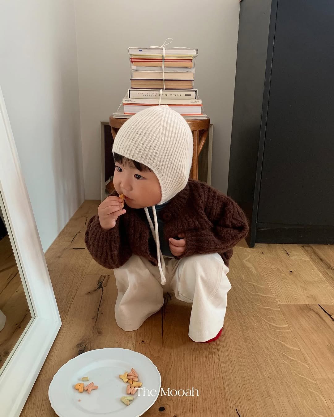 Photo by The Mooah on October 14, 2025. May be an image of baby, duffle coat, hat, beret, face mask and text.