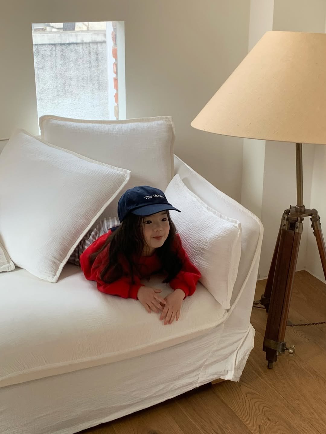 Photo by The Mooah on February 12, 2026. May be an image of child, hat, duffle coat, beanbag chair, lamp shade, chaise lounge and text.