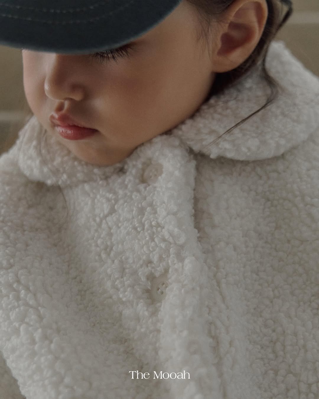 Photo by The Mooah on December 17, 2025. May be a closeup of child, duffle coat, hat, goosedown coat, fur, parka and text.