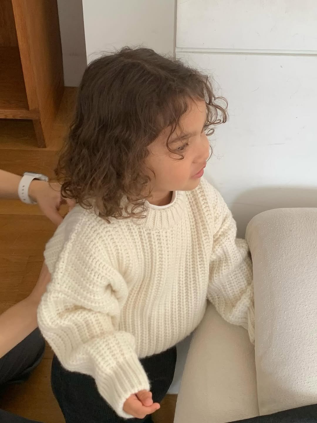 Photo by The Mooah on September 15, 2025. May be an image of 1 person, baby, hair, knit, cardigan and text.