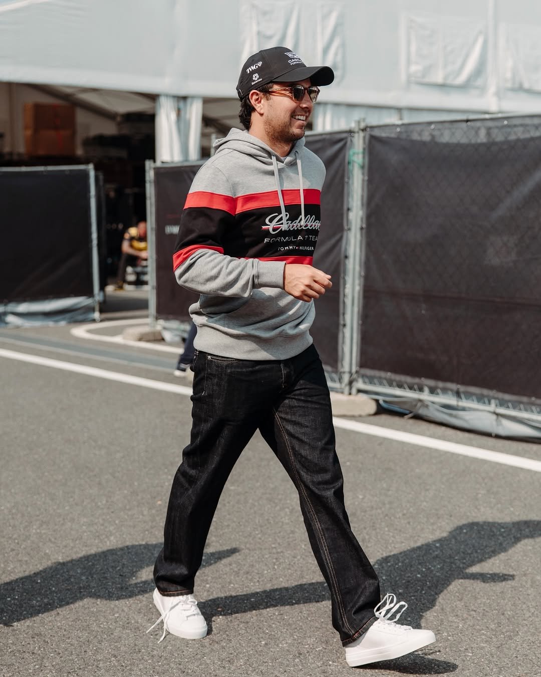 Photo shared by Cadillac Formula 1 Team on March 28, 2026 tagging @tommyhilfiger, and @schecoperez. May be an image of sneakers, sportswear, sweatpants and text.