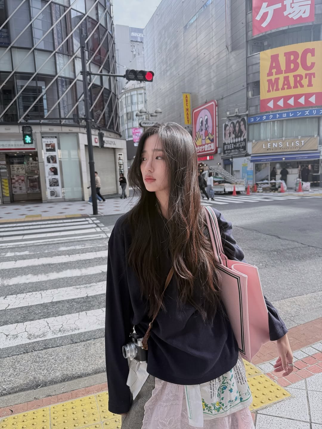 Photo by ตู / t u on April 26, 2026. May be an image of one or more people, braids, miniskirt, street and text.