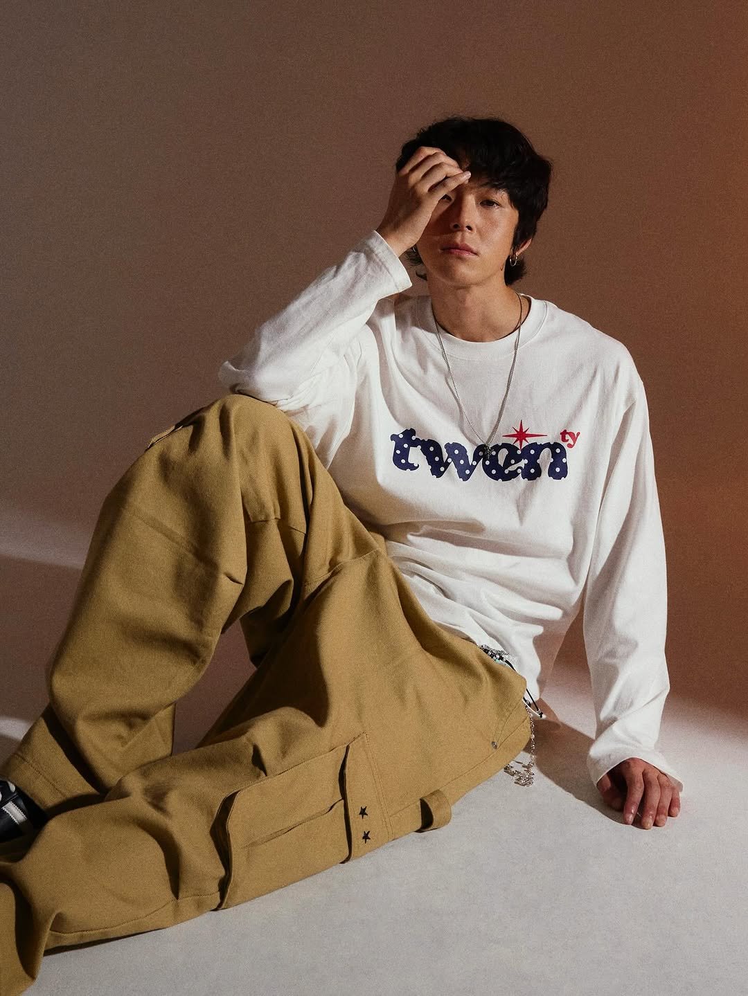 Photo by 트래블 공식 인스타그램 TRAVEL on August 25, 2025. May be an image of 1 person, bangs, top, bolo tie, sweatpants and text.