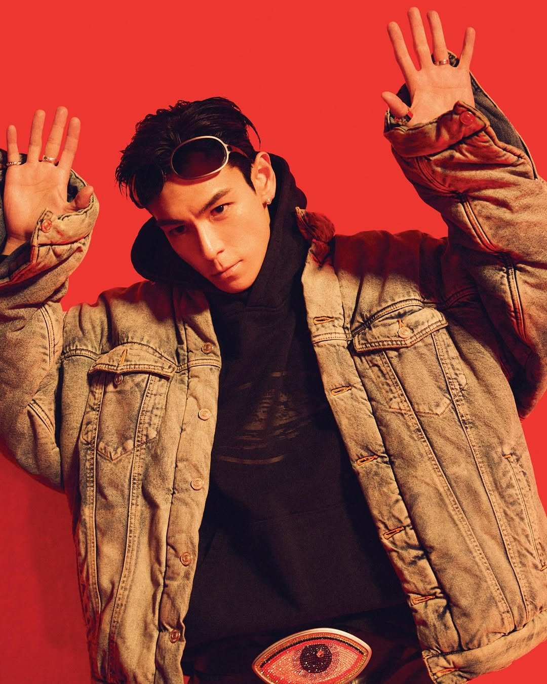 Photo shared by T.O.P on March 16, 2026 tagging @topspot_pictures. May be pop art of overcoat, duffle coat, magazine, turtleneck, glasses and text.