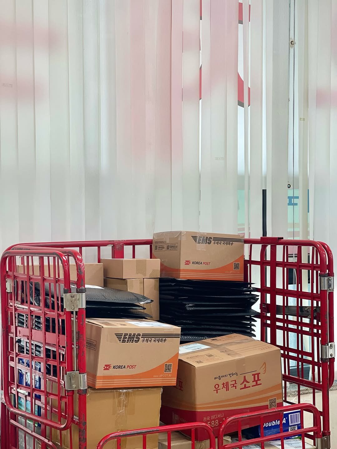 Photo by 터틀넥프레스 on July 31, 2025. May be an image of carton, rack, cart, plastic bag, shopping cart and text.