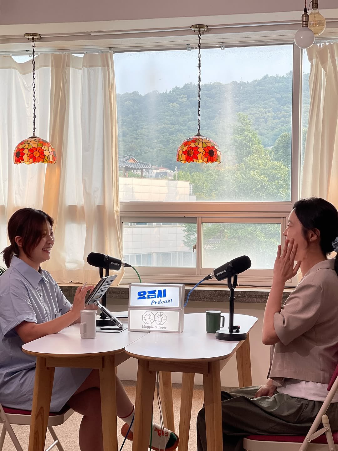 Photo shared by 터틀넥프레스 on August 09, 2025 tagging @hola_lea, @yozmsa, and @sahara.diary. May be an image of 2 people, microphone, camcorder and text.