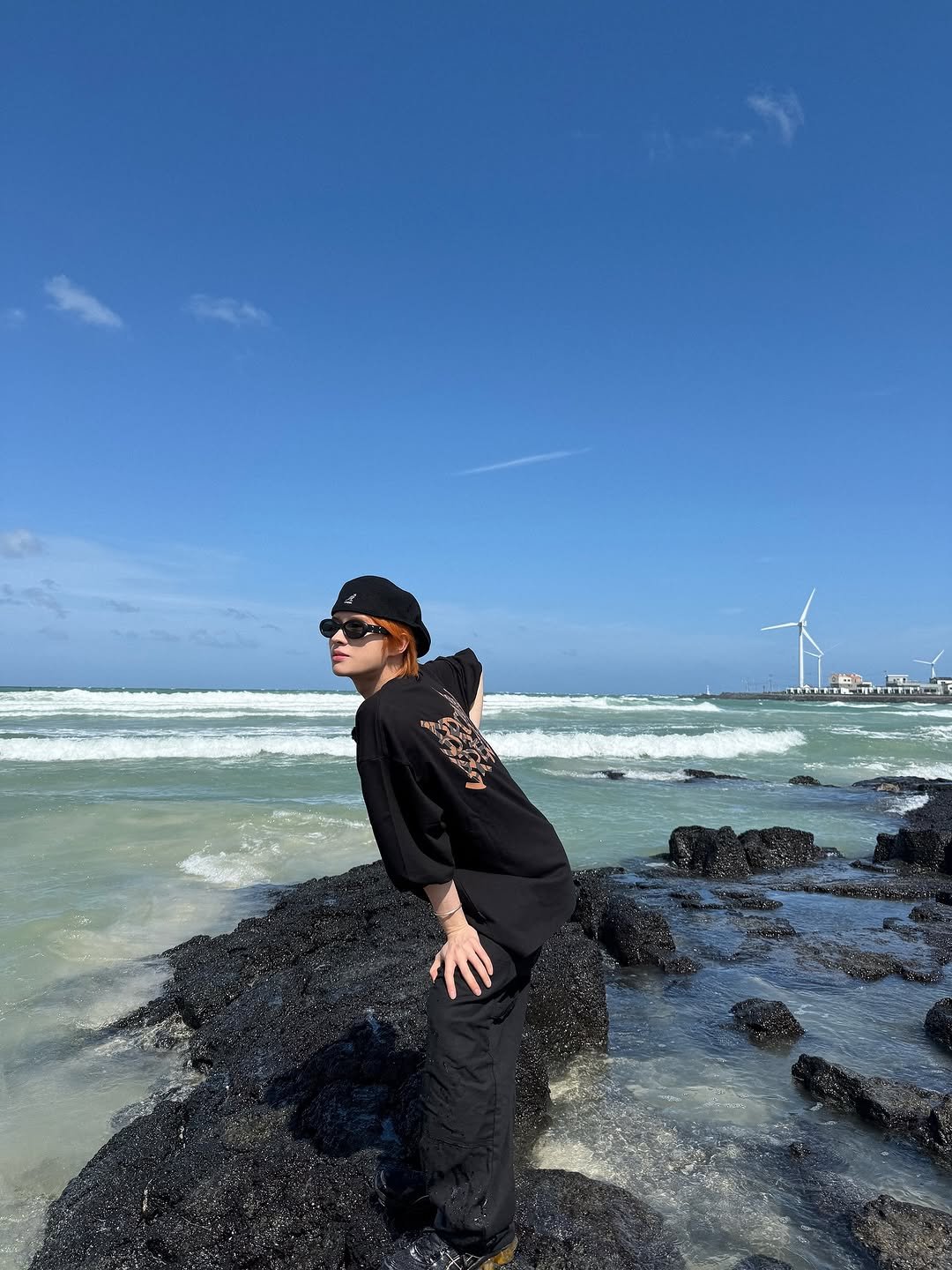 Photo by TWS (투어스) on November 16, 2025. May be an image of ocean, windmill, coast and text.