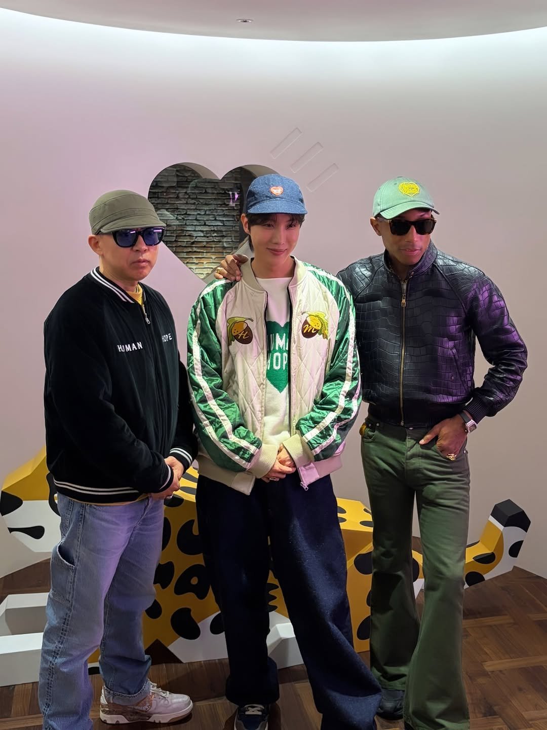 Photo shared by jhope on November 21, 2025 tagging @nigo, @humanmade, and @pharrell. May be pop art of ‎standing, beret, glasses, portable cassette player, military uniform, helmet and ‎text that says '‎確 HUMAN Mi OP زنه‎'‎‎.