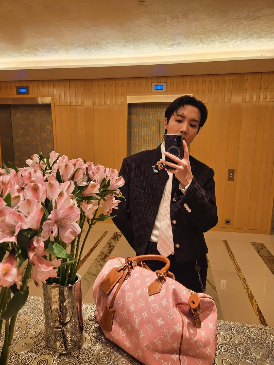 Photo shared by jhope on June 24, 2025 tagging @louisvuitton. May be an image of luggage, prairie gentian and baby's-breath.