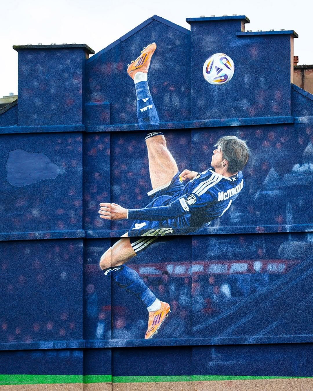 Photo shared by UEFA EURO on February 20, 2026 tagging @scotlandnationalteam, and @scottmctominay. May be an image of soccer, football, brick wall and text.