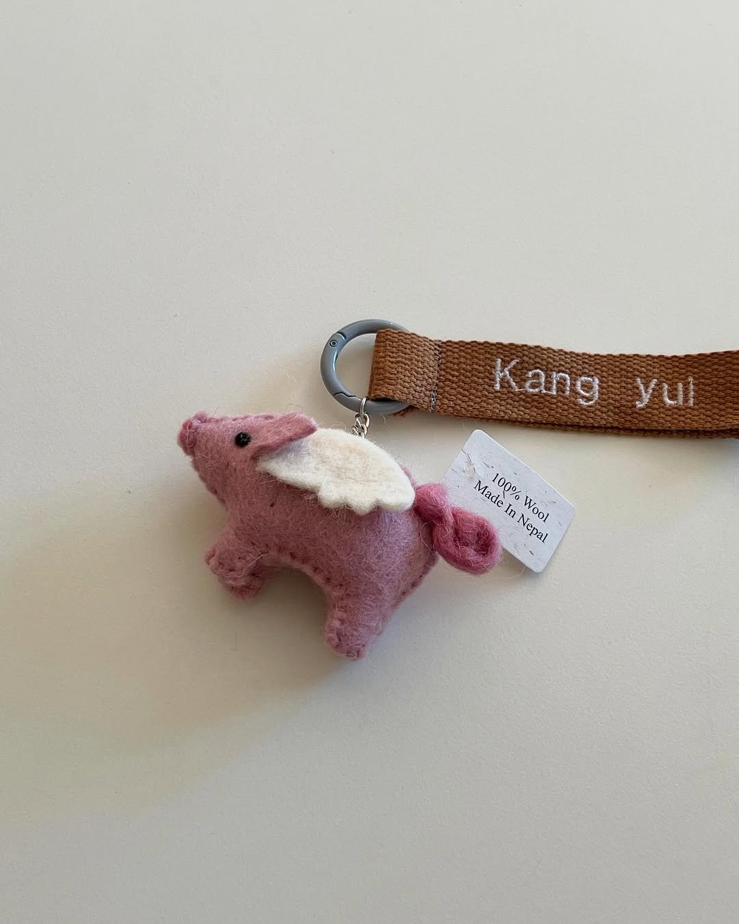 Photo shared by 유 어 메 세 지 on December 22, 2025 tagging @urmessage_. May be an image of elephant, rhinoceros, key and text that says 'Kang yul Made 1000 Nepal m Wool'.