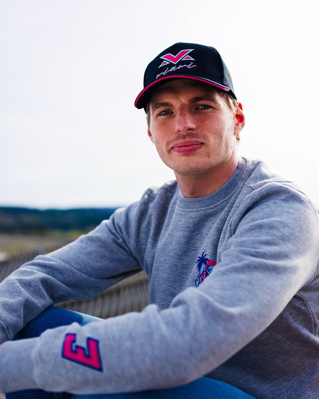 Photo by Verstappen.com on April 25, 2026. May be an image of one or more people, hat, sweater, fleece, sweatshirt and text.