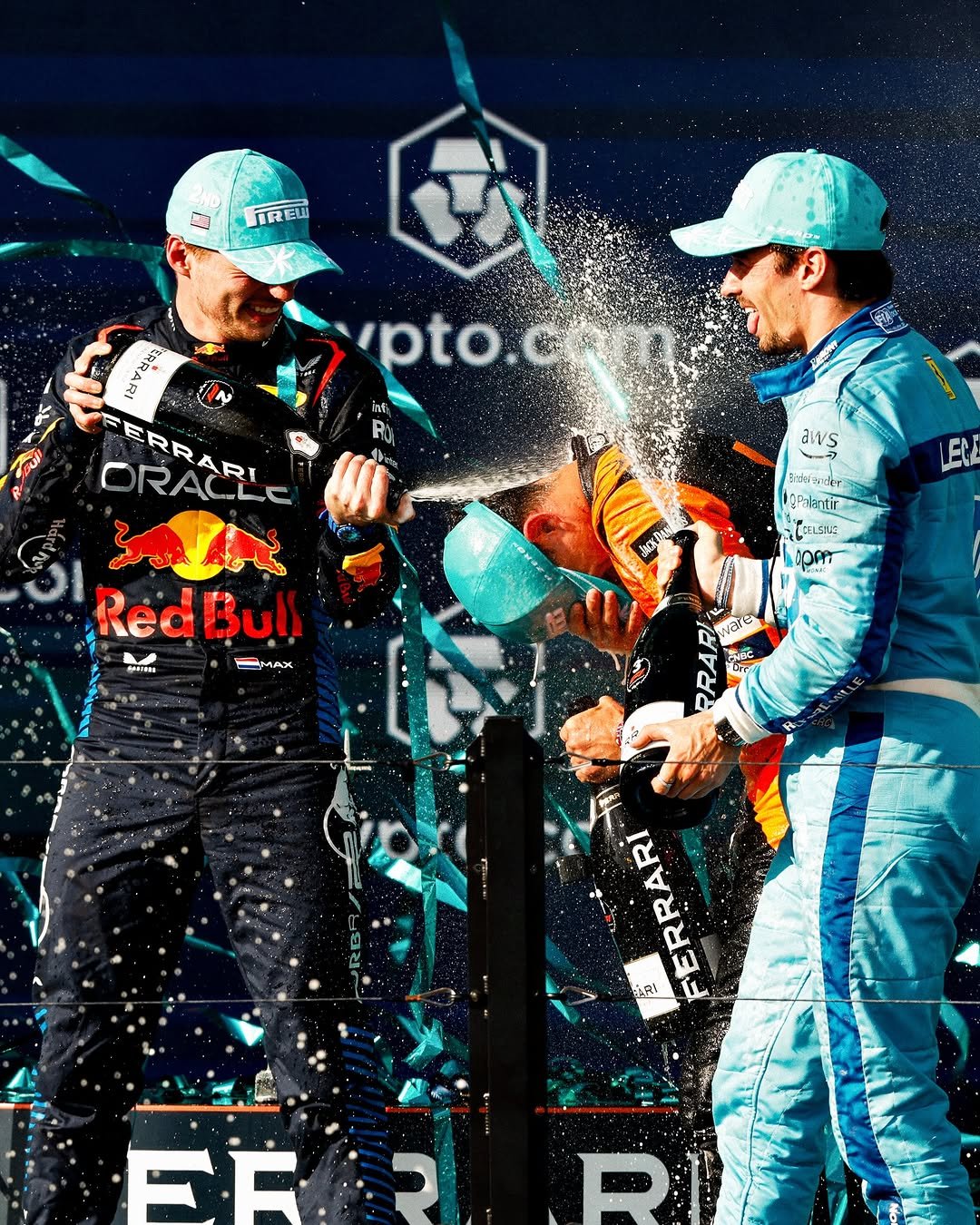Photo shared by Verstappen.com on April 26, 2026 tagging @maxverstappen1, @charles_leclerc, and @lando. May be an image of ‎racing vehicles, race car, helmet and ‎text that says '‎TREW 安 น ipto.c inf ja부업산3 ብቅክ B3 اله ORACL ERRARI જા אוב RedBull Bull E -MAX M MAS aws ฉะชวิม nder Palantir ုးးး CDAT FERRARI ARI FR‎'‎‎.