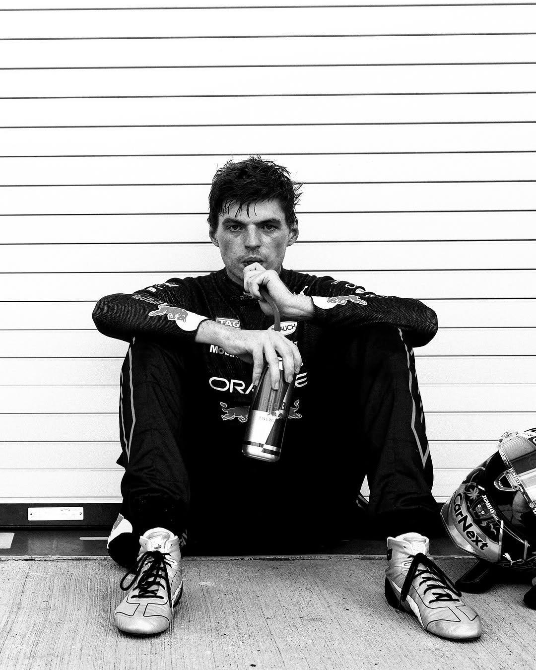 Photo shared by Verstappen.com on April 26, 2026 tagging @maxverstappen1. May be a black-and-white image of ‎one or more people, cigarette, harmonica, sweatpants and ‎text that says '‎ITAG MCH M OR G ጉፋል و ED‎'‎‎.