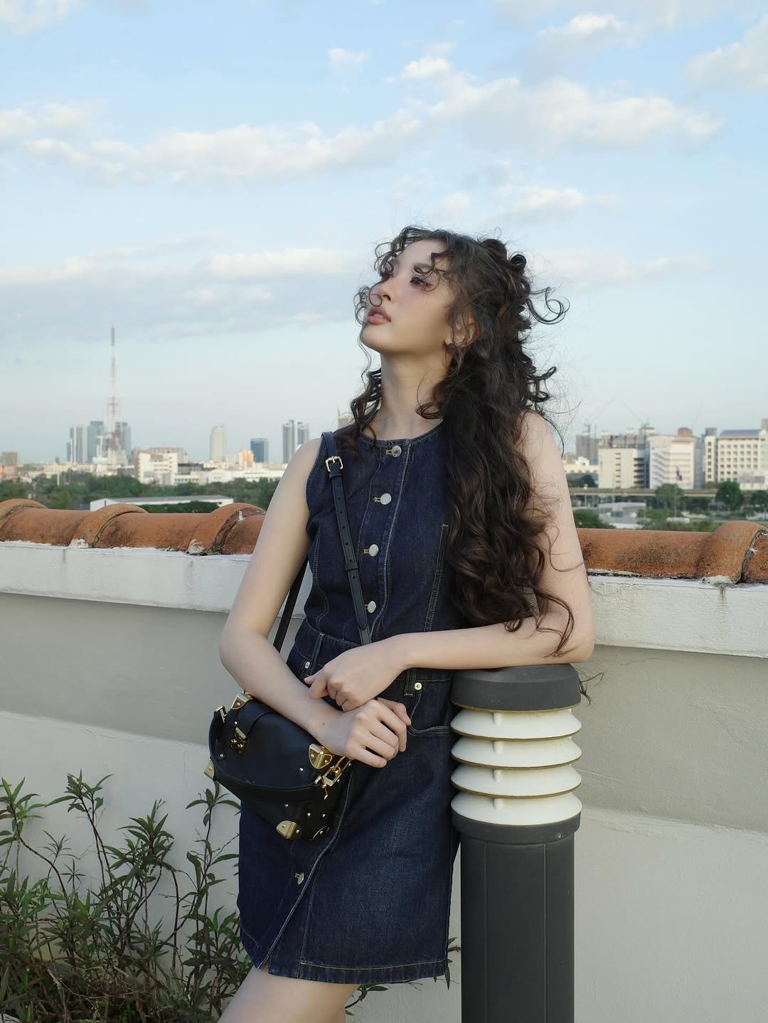 Photo shared by Benyapa j. on December 19, 2025 tagging @louisvuitton. May be an image of one or more people, hair, skyscraper and text.