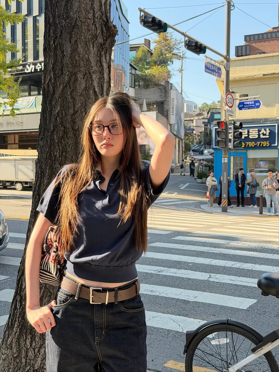 Photo by Benyapa j. on November 05, 2025. May be an image of eyewear, miniskirt, street and text.