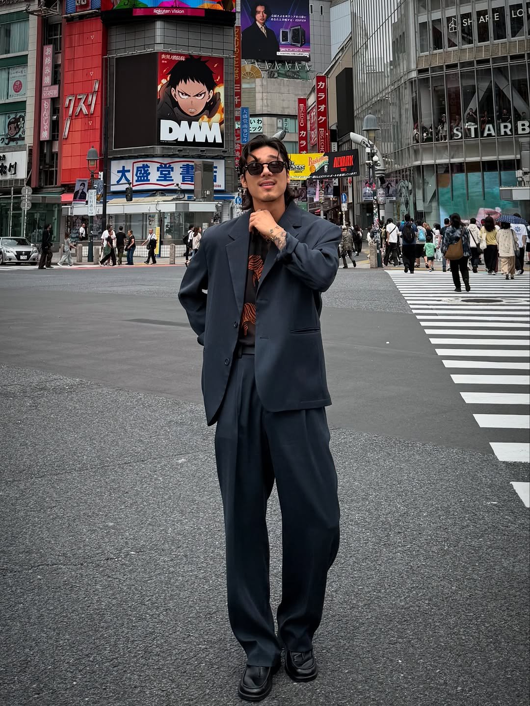 Photo shared by 비 르 on June 13, 2025 tagging @virstyle.kr. May be an image of 12 people, suit, Times Square, street and text.
