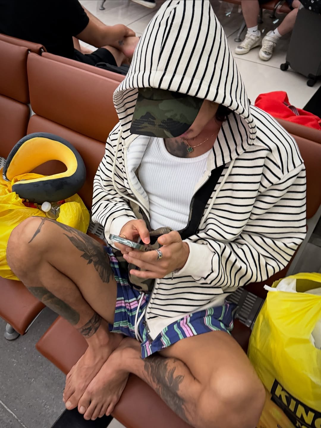 Photo shared by 비 르 on September 14, 2025 tagging @virstyle.kr. May be an image of 1 person, phone, hat, face mask, raincoat, bath robe, headscarf, parka and text.