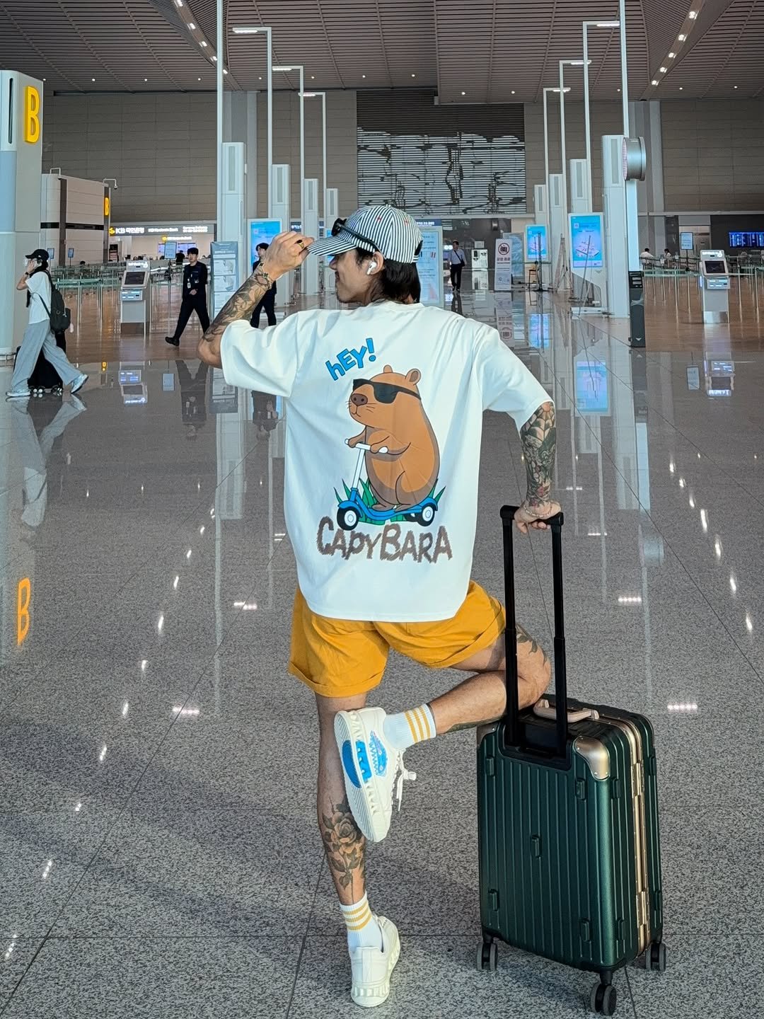 Photo shared by 비 르 on June 12, 2025 tagging @virstyle.kr, and @78under_official. May be an image of 3 people, suitcase, luggage, terminal and text that says 'B .. hEY! CAPOYBARA'.