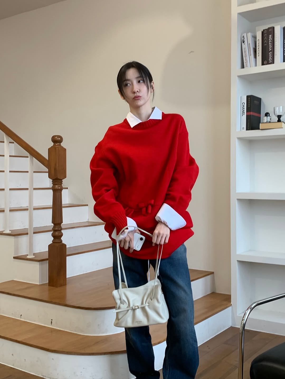 Photo shared by 박지현 on October 30, 2025 tagging @prada. May be an image of duffle coat, sweater, sweatshirt, turtleneck and text.