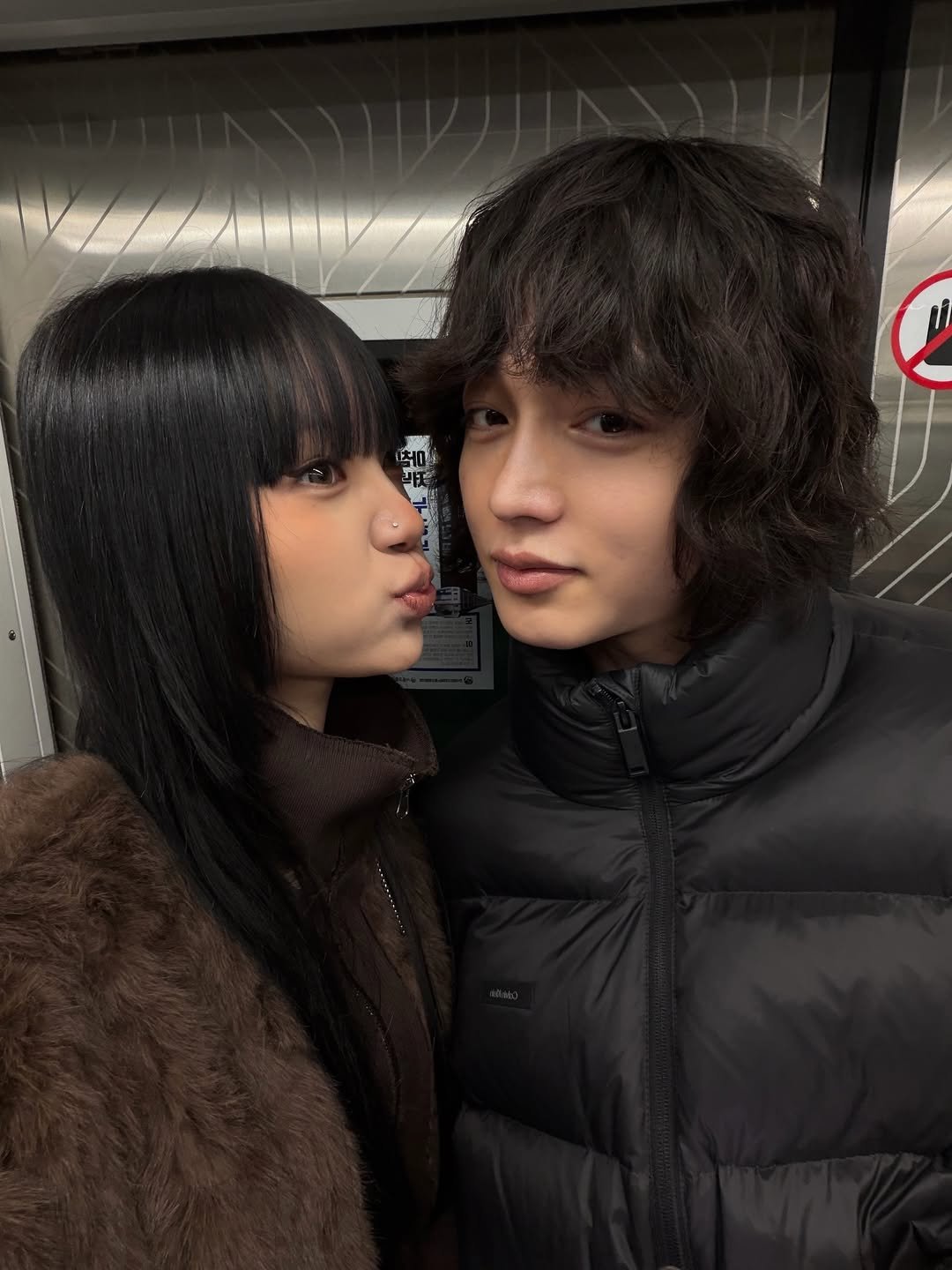 Photo shared by 왕십리 커플🤍 on November 27, 2025 tagging @wangsimniboy, and @bobaerit. May be an image of one or more people, bangs, people kissing, duffle coat, parka and text.
