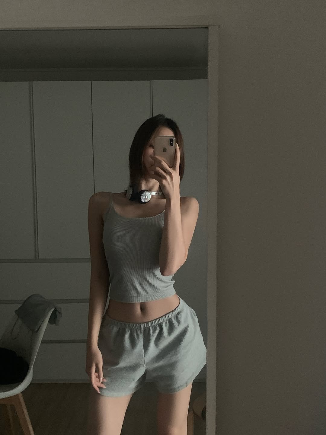 Photo by swan on August 11, 2025. May be an image of 1 person, sleepwear, phone, shorts, sweatpants, mirror and text.