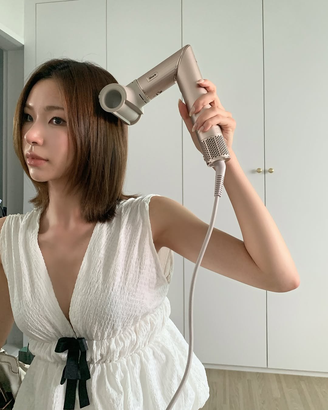 Photo shared by swan on July 30, 2025 tagging @sharkbeauty, and @sharkninjakr. May be an image of 1 person, hair, hair dryer and text.