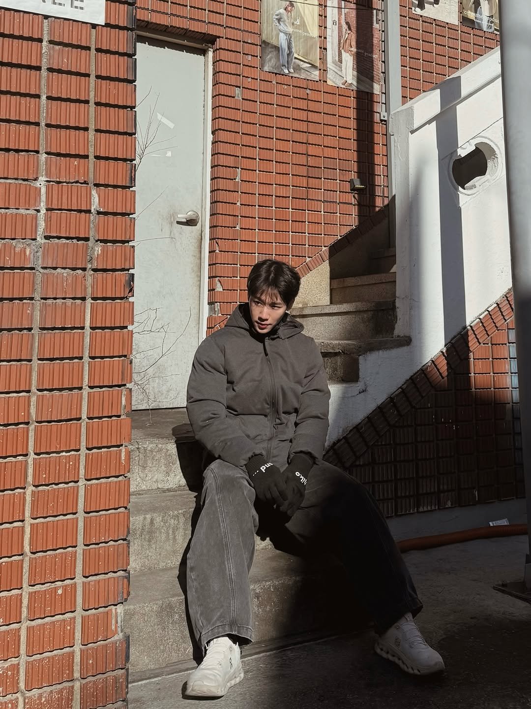 Photo by w on February 19, 2026. May be an image of fire escape, outerwear, brick wall and text.