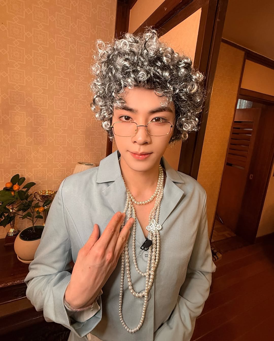 Photo shared by WayV on February 17, 2026 tagging @djxiao_888. May be an image of one or more people, bangs, makeup, bolo tie, top and text.