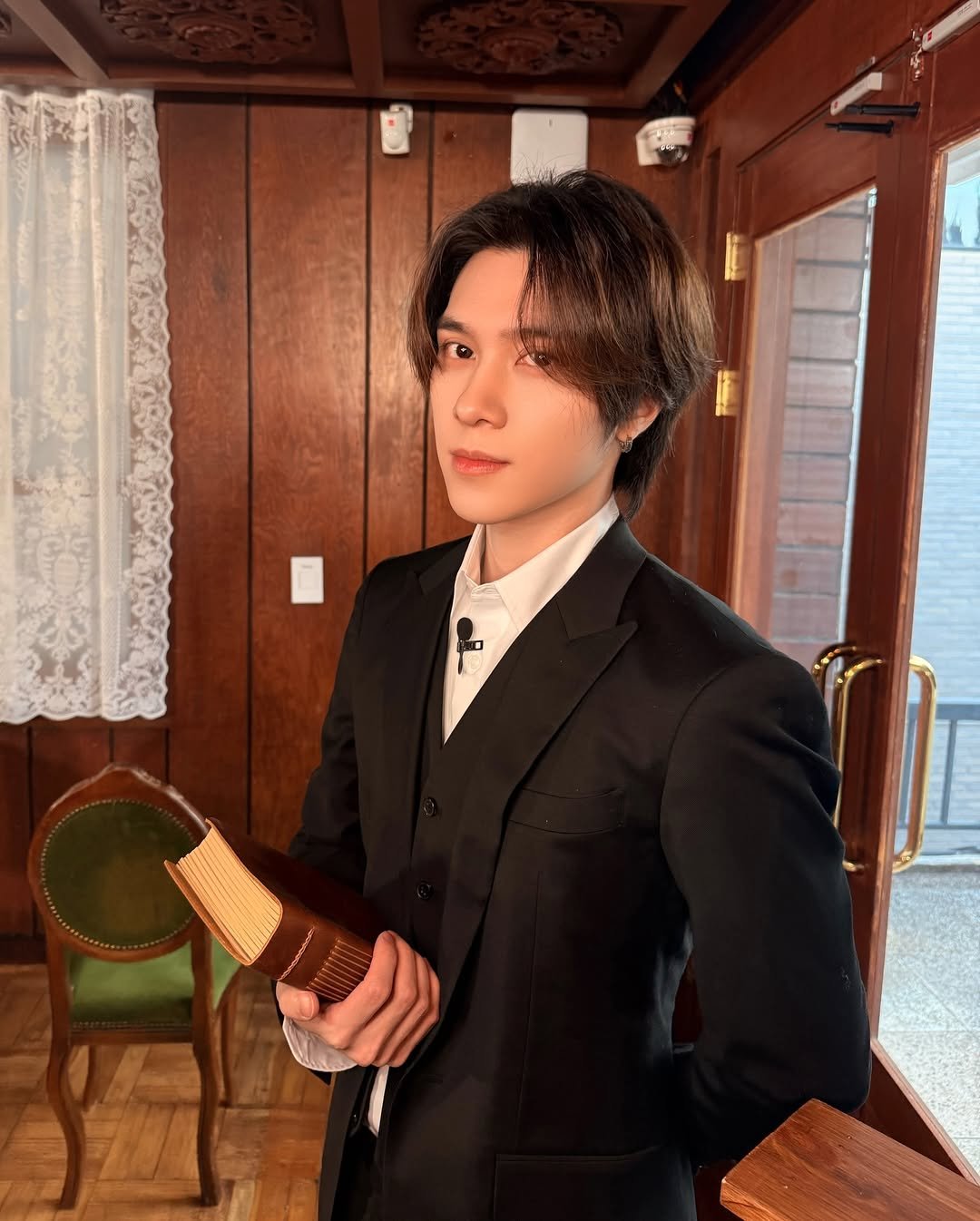 Photo shared by WayV on February 17, 2026 tagging @i_m_hendery. May be an image of one or more people, hair, bolo tie and text.