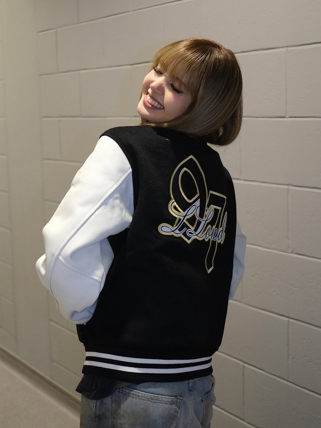 Photo shared by LLOUD on December 08, 2025 tagging @lalalalisa_m. May be an image of one or more people, bangs, top, flight jacket, parka and text.