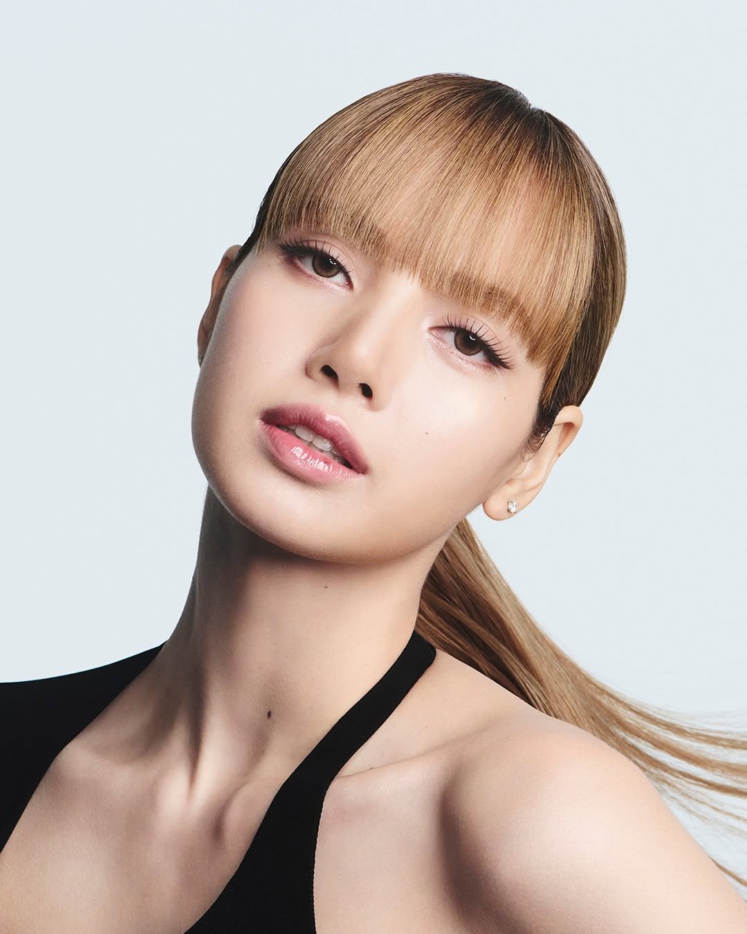Photo shared by LLOUD on February 08, 2026 tagging @shiseido, and @lalalalisa_m. May be a closeup of one or more people, bangs, blonde hair, makeup and text.