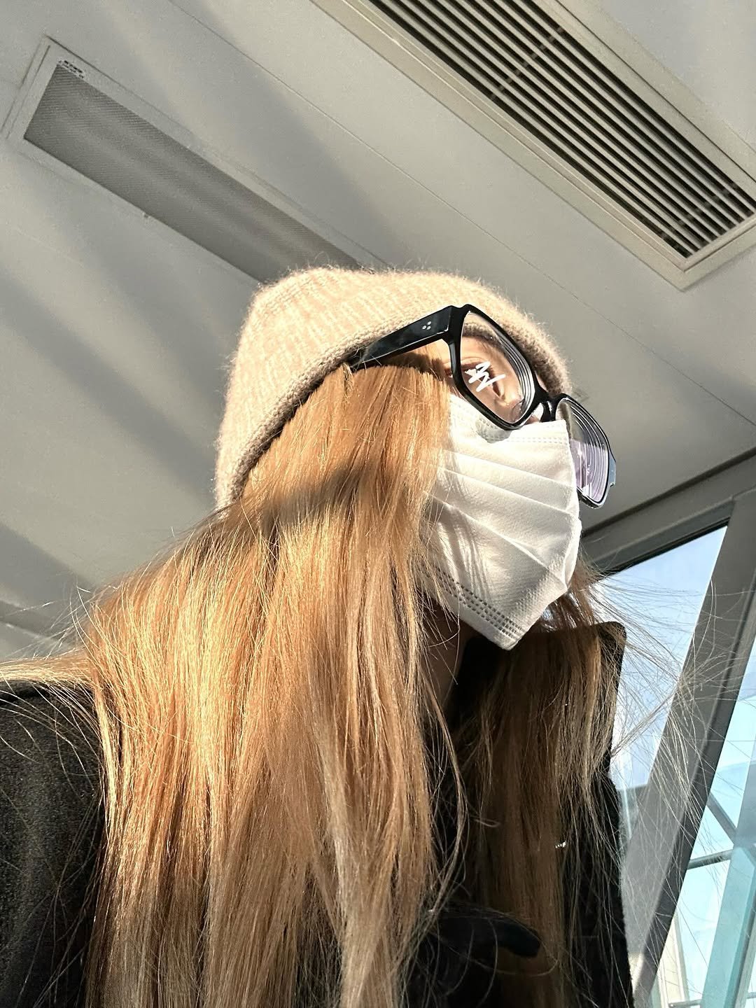 Photo by SHEN XIAOTING on February 19, 2026. May be a selfie of one or more people, blonde hair, face mask, bus and text.