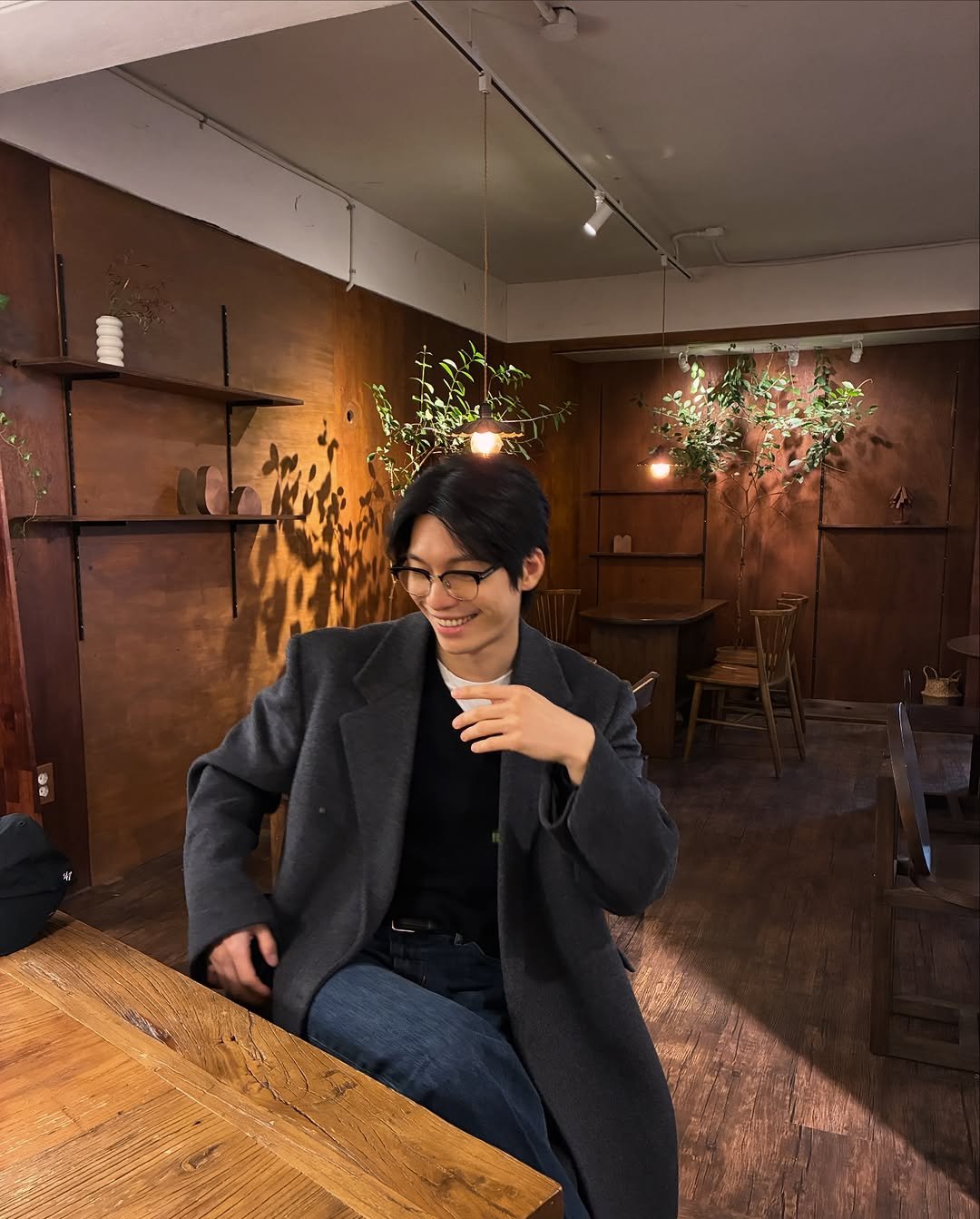 Photo by 위하준 Wi Ha Jun on February 11, 2026. May be an image of duffle coat, overcoat, drink, cornflower and text.