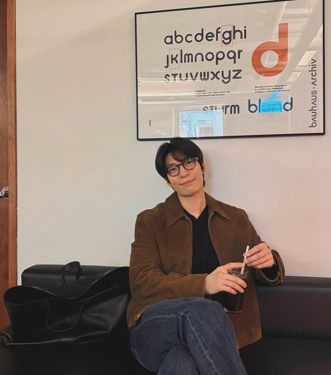 Photo by 위하준 Wi Ha Jun on March 24, 2026. May be an image of duffle coat, eyeglasses, poster, magazine, cornflower and text.