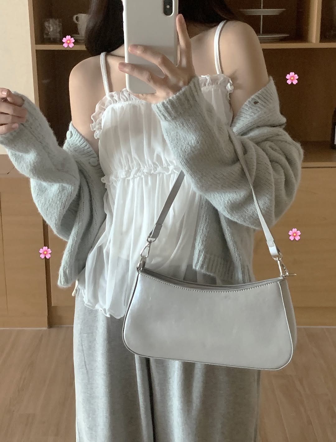 Photo by 윈미룸winmiroom on February 26, 2026. May be an image of sleepwear, purse, drawstring and text.
