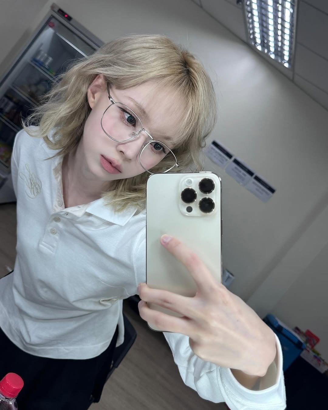 Photo shared by aespa 에스파 WINTER 윈터 on July 14, 2025 tagging @aespa_official, and @imwinter. May be a selfie of 1 person, bangs, blonde hair, eyeglasses, mirror and text.