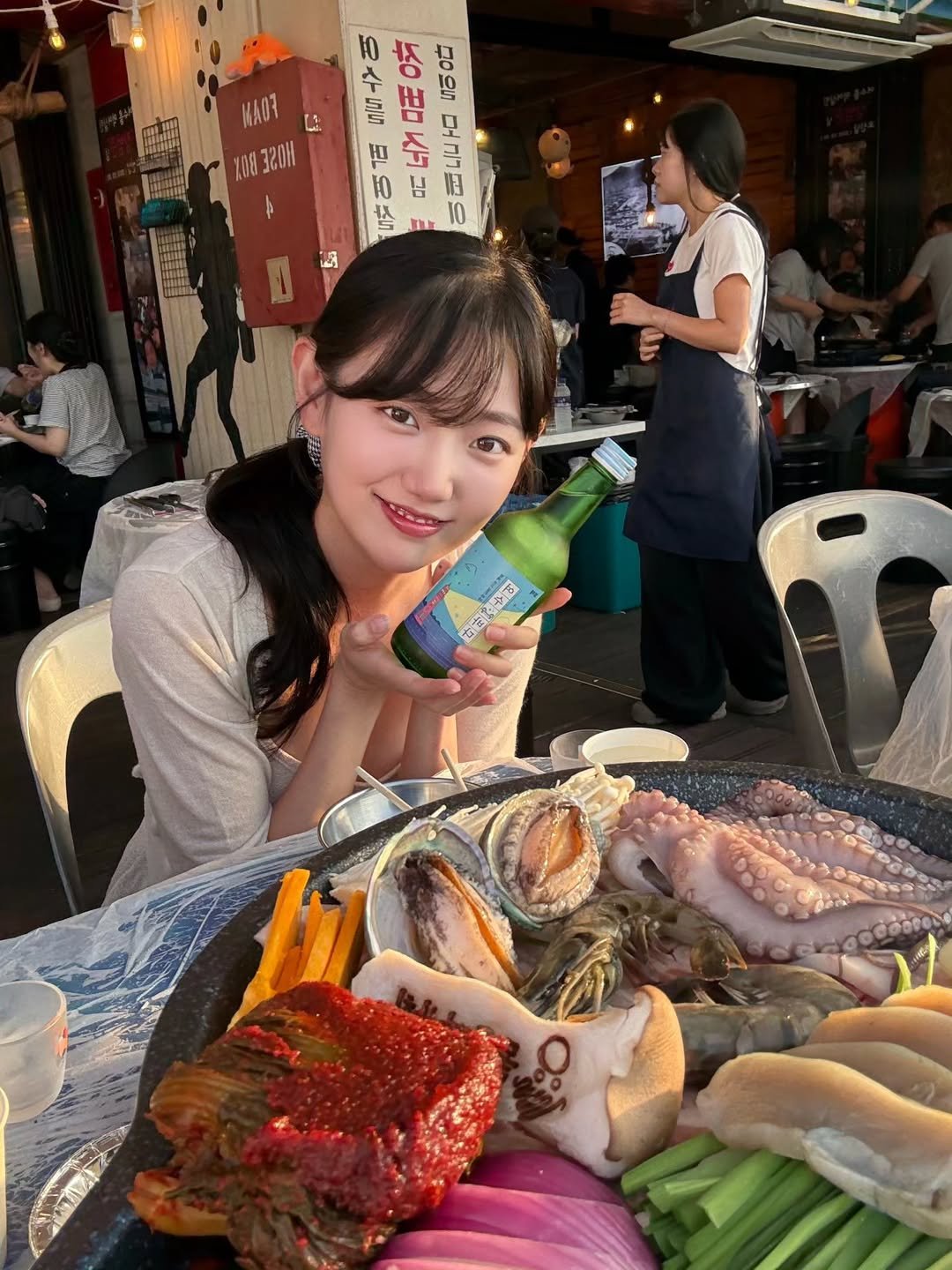 Photo by 조채윤 on August 12, 2025. May be an image of 6 people, octopus, skewer, oyster and text.