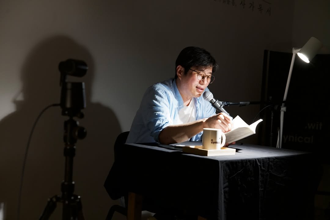 Photo by 시집서점 위트 앤 시니컬 on August 12, 2025. May be an image of 1 person, studying, tripod and text.