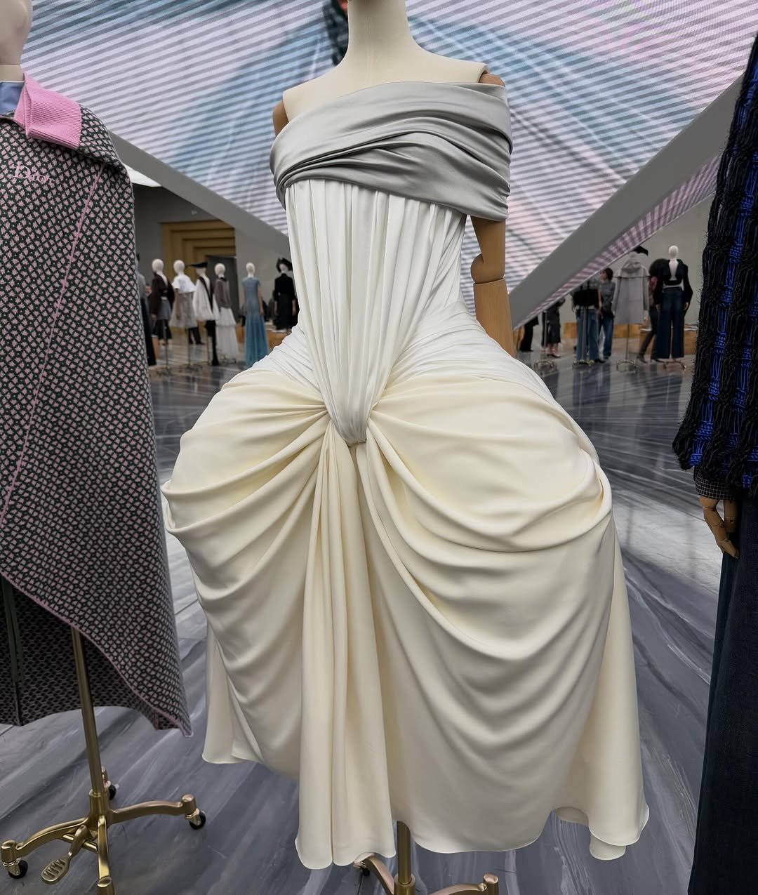 Photo shared by W Korea on October 02, 2025 tagging @dior. May be an image of 12 people, mannequin, gown and text.