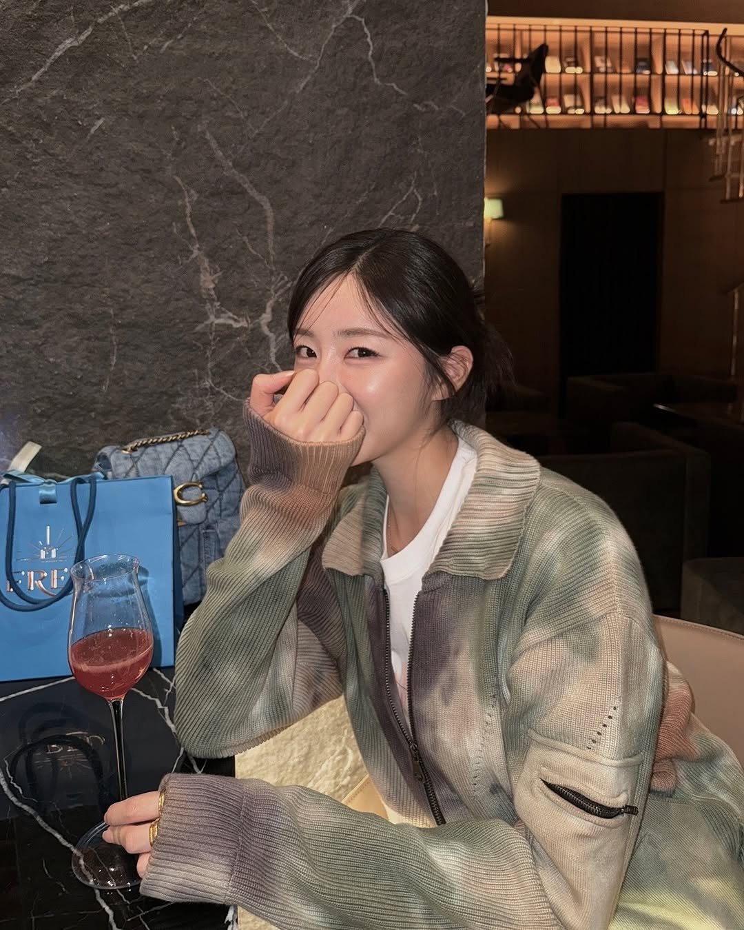 Photo by 안지현 on March 23, 2026. May be an image of one or more people, hair, drink, flight jacket and text.