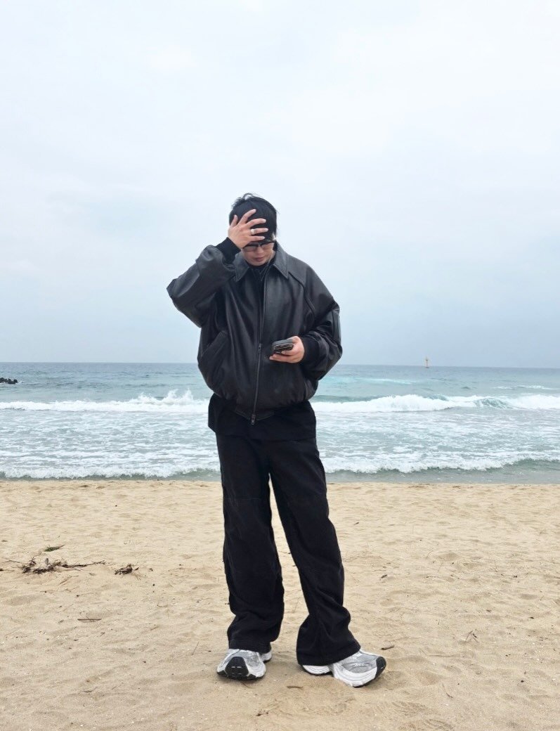 Photo shared by 김상우 on March 16, 2026 tagging @balenciaga, @bvlgari, @miumiu, @lookbox._, @snatched_outfit, @juun.j_official, @outfitbattles_korea, @hiphye_official, @fashionsangsa, and @howmuch_official. May be an image of standing, face mask, parka, ocean, water, beach, coast and text.