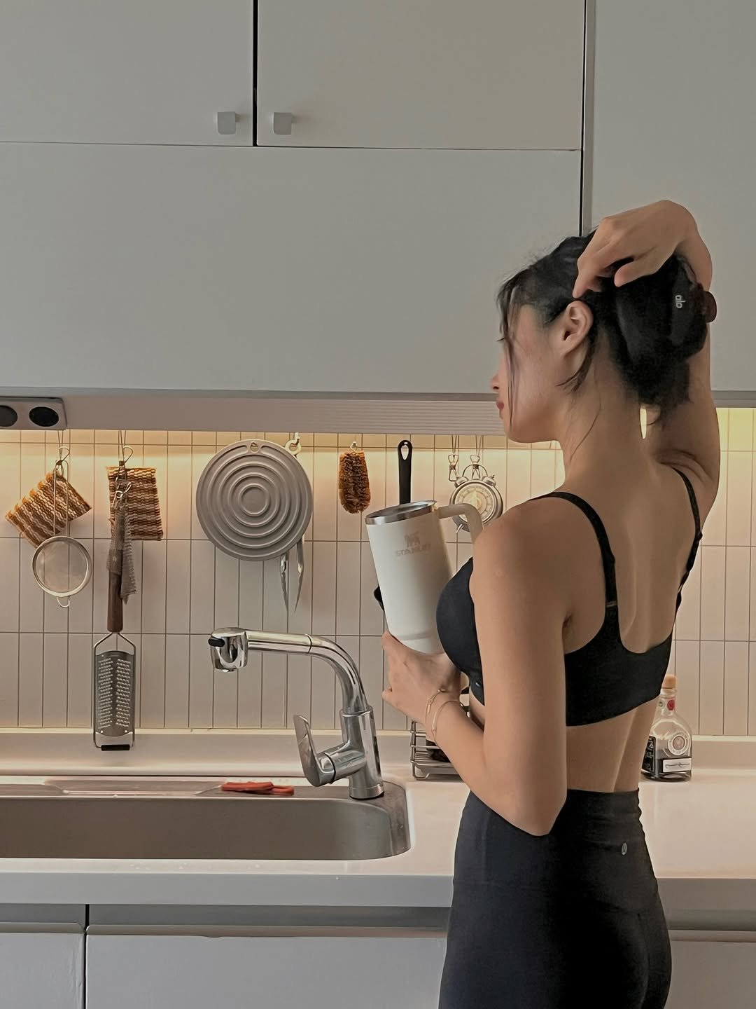Photo by 우나스 woonas on August 03, 2025. May be an image of 1 person, drink, activewear, water filter, bra, coffee maker, faucet and text.